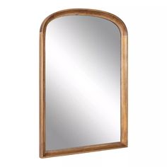 an arched wooden mirror on a white wall