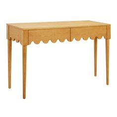 a wooden table with scalloped legs and a drawer on one side, against a white background