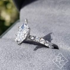 a diamond ring sitting on top of a rock