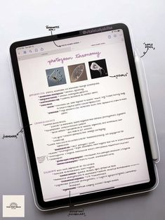 a tablet with some type of text on it next to a pen and paper clippings