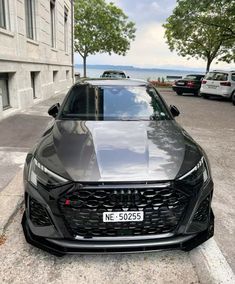 a black car parked in front of a building