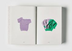 an open book with two sweaters cut out of it's pages, one in green and the other in purple