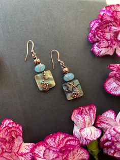 These gorgeous earrings feature a vibrant blue aventurine bead with a square abalone bead wrapped under it. Solid copper wire swirls around the earrings. They are oxidized and polished by hand to highlight the wire work. They will arrive in a cute gift box with crystal gift.  Earring Measurements Length-50mm/2.00in Width-16mm/0.63in Please note- These earrings are already made, allow 1-2 business days to ship. All domestic orders will be sent USPS first class mail with tracking. International or Wire Swirls, Copper Earrings Handmade, Art Jewelry Earrings, Blue Aventurine, Abalone Earrings, Unique Handmade Earrings, Rustic Earrings, Stone Dangle Earrings, Paper Bead Jewelry