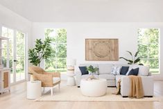 a living room filled with furniture and lots of natural light coming in through the windows