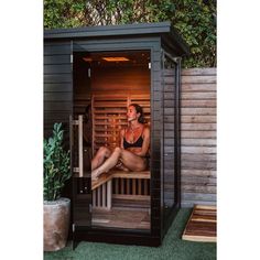 a woman is sitting in the sauna