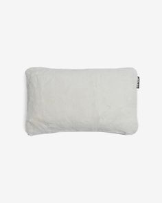 a white pillow that is on top of a table