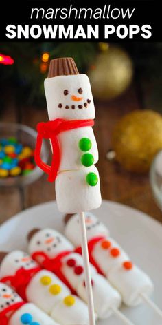 marshmallow snowman pops on a white plate