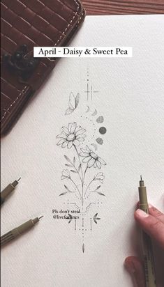 someone is drawing flowers on paper with markers