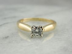 Incredibly simple and yet overwhelmingly perfect, the sheer quality of this vintage diamond engagement ring really allows it to stand out among newer, more ornate styles. It has a nice presence on the finger, not too high, comfortable and easy to wear. The diamond is set into a secure four prong mounting, supported and framed by polished tapered classic shoulders and subtly accented on it's side view with tiny diamonds set into the gallery. Utter simplicity, the focus of this ring is truly the i Small Diamond Rings, Diamond Engagement Rings Vintage, Cameo Ring, Tiny Diamond, Colored Gems, Diamond Solitaire Engagement Ring, Vintage Diamond, Diamond Solitaire, Diamond Studs