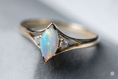 Minimalist Marquise-Cut Australian Solid Opal Diamond Ring 14K Yellow Gold. Free Domestic USPS First Class Shipping! Free One Year Limited Warranty! Free Gift Bag or Box with every order! Opal—the queen of gemstones, is one of the most beautiful and rarest gemstones on earth. Every piece of opals has its colors and patterns, which is perfect for designers to create unique engagement rings for someone extra special. We use 100% Natural & Ethically opal stones (NO synthetics or imitations) for our Opal Engagement Ring Rose Gold, Opal Promise Ring, Marquise Cut Diamond Ring, Gold Moonstone Ring, Wedding Rings Art, Opal Diamond Ring, Alternative Wedding Rings, Australian Black Opal, Opal Birthstone