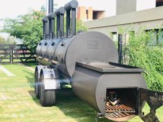 an outdoor bbq grill sitting in the grass