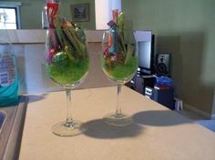 two wine glasses filled with green liquid and candy