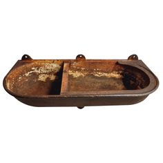 an old rusted metal tray with two compartments