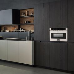 a modern kitchen with dark wood cabinets and stainless steel appliance in the center