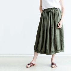 "Handmade with love and care Oeko-tex certified 100% linen skirt which is crafted by local tailors in Lithuania (EU member). It goes perfectly with any of our blouses (you will find below some recommendations)! Look sharp all day long! Length: 32\"/80cm (we will gladly make adjustments) Pockets: yes Waistband: elastic Details: *Colour shown: desert sage / forest green *Model is wearing size M *High-waisted *Deep pockets *Medium weight (185 g) *Not-ironed (and no need to) *Handcrafted by @LinenCl Casual Linen Tiered Skirt, Casual Linen Tiered Skirt Bottoms, Relaxed Linen Skirt With Elastic Waistband, Flowy Linen Skirt With Elastic Waistband, Casual Linen Gathered Skirt, Linen Flowy Skirt With Lining, Casual Linen Gathered Skirt Bottoms, Linen Midi Skirt With Elastic Waistband, Spring Linen Skirted Bottoms