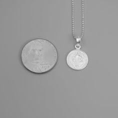 St. Benedict full-body image and a cross in the back Material that is extremely durable and hypoallergenic A powerful message of spiritual protection The front and back of this pendant are finely detailed, and the chain that it hangs from is no exception. The delicate details are embossed in a silver tone for better shine and shadowing for better contrast. This double-sided necklace is a must-have accessory. Pair this with any other necklace for a stylish and modern look. Dimensions & Specificat Catholic Cross Necklace, Saint Benedict Medal, Saint Necklace, St Benedict Medal, Catholic Necklace, Benedict Medal, Saint Jewelry, St Benedict, Catholic Jewelry