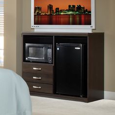 there is a television on top of the entertainment center in this bedroom with a bed