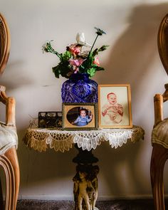 a small table with flowers and pictures on it