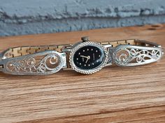 Vintage watch Seagull. Miniature women's watch. They look elegant on the wrist and go well with other accessories. This accessory can be a great gift for a loved one. Ideal as a gift. Characteristic: Mechanism - mechanical. Case size - 16 * 20 mm (0.62 * 0.78 inch) Strap length - 19.5 mm. (7.48 inch) Case color - silver. Dial color is black. Housing - coating. Condition - vintage, traces of use. The watch is over 30 years old, in decent condition for its age. The watch works properly and shows accurate time, and is serviced by a professional watchmaker. Please note that the watch is mechanical and must be wound by hand daily. If you have any questions for me. I will be happy to answer them. Visit my store here: https://odessa13watch.etsy.com PLEASE NOTE All of our items are vintage and sol Vintage Metal Watch Accessories, Vintage Metal Round Watch Accessories, Elegant Metal Watches With Skeleton Dial, Vintage Jewelry And Watches With Round Dial For Gift, Vintage Watch Accessories With Skeleton Dial For Gift, Vintage Skeleton Dial Watch Accessories For Gift, Vintage Skeleton Dial Watch Accessories As A Gift, Vintage Engraved Watch Accessories As Gift, Vintage Metal Dial Watches For Evening