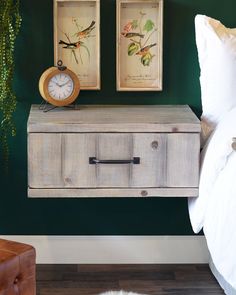 a bedroom with two framed pictures on the wall