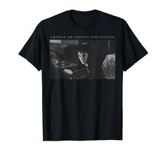 a black t - shirt with an image of a man holding a book in front of him