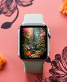 an apple watch sitting on top of a pink surface with flowers and butterflies around it