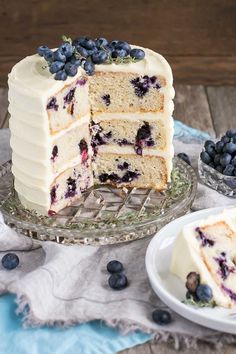 a cake with blueberries on top is cut into slices and served on a plate