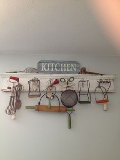 a wall mounted kitchen utensils and other items