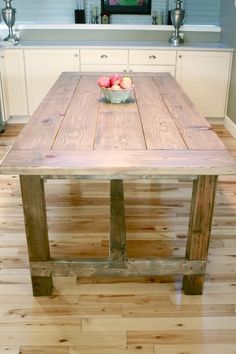 a wooden table sitting in the middle of a kitchen