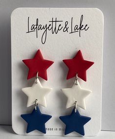 These red, white and blue polymer clay earrings are perfect for all of your 4th of July festivities. Each of the three stars measure .75 inches by .75 inches and the entire earring is 2.25 inches.  The stars are attached with a silver ring. Each pair of earrings is one-of-a-kind, made by me, so any slight imperfections or variances make them unique. There also could be small air bubbles, scratches, and may slightly differ from the picture you see here. Polymer clay is lightweight, durable and can last a long time with proper care: * Remove before showering, swimming, exercising, and bedtime * Allow lotions and perfumes to dry before wearing * Store away from direct sunlight * To clean your earrings use a damp cloth and wipe gently. I do not offer refunds or exchanges due to hygiene reasons Patriotic Red Star-shaped Earrings, Patriotic Red Star Earrings, Patriotic Blue Star Jewelry, Patriotic Blue Star Shaped Jewelry, Patriotic Blue Star-shaped Jewelry, White Dangle Earrings For 4th Of July, Blue Polymer Clay Earrings, Blue Polymer Clay, Wear Store