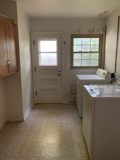 an empty laundry room with tile flooring and white appliances on the counter top, next to a washer and dryer