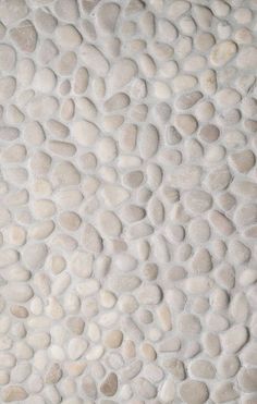 a wall made out of rocks with white pebbles on it's sides and the bottom