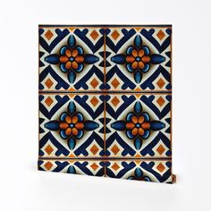 a blue and orange tile design with an orange flower in the center on a white background