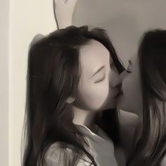 two women are kissing each other in front of a mirror