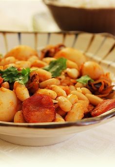 a bowl filled with pasta and meat on top of a table