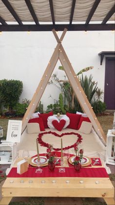 an outdoor seating area with red and white decor