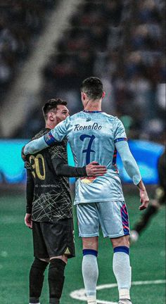 two soccer players are embracing each other on the field