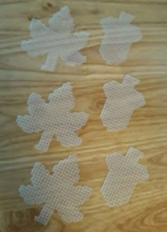 four pieces of white plastic sitting on top of a wooden table