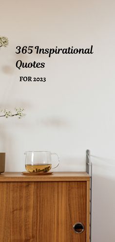 there is a vase with flowers on top of a dresser next to a wall that says, 365 inspirational quotes for 202