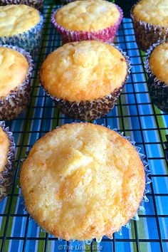 lemon muffins on a cooling rack with the words sour cream lemon muffins