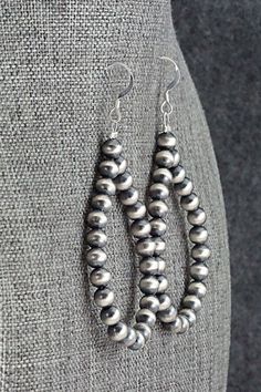 These sterling silver bead earrings were made by Navajo silversmith Louise Joe.Length: 2 5/8"Width: 1 1/4"Bead Size: 3/16"Free shipping on all orders! We ship with USPS and always include tracking. All orders ship within a day of payment.Returns are accepted up to 30 days after you receive your order. Just send us a message. Our shop offers cash back or store credit. The item must be returned in new condition. Southwestern Sterling Silver Beaded Jewelry, Southwestern Silver Jewelry With Spacer Beads, Southwestern Style Silver Jewelry With Polished Beads, Artisan Sterling Silver Jewelry With Spacer Beads, Artisan Jewelry With Spacer Beads In Sterling Silver, Artisan Silver Earrings With Silver Beads, Silver Bead Artisan Earrings, Silver Beaded Earrings With Polished Beads As Gift, Southwestern Sterling Silver Hand-strung Jewelry