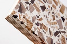 a close up view of a piece of wood that has been cut into squares and triangles