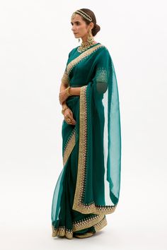 Emerald green saree in silk organza base with hand embroidered gota and marodi border. Paired with silk blouse and matching modal satin petticoat.
Components:3
Embroidered
Neckline:Round
Sleeve Length:Elbow
Fabric:Pure Silk Organza, Habutai Silk, Pure Modal Satin; Lining: Cotton
Color:Green
Placement back embroidered blouse
Concealed zipper closure blouse
Gota, mukaish and marodi work
Modal satin green petticoat - Aza Fashions Emerald Green Saree, Marodi Work, Gota Patti Saree, Blouse Neck, Green Saree, Green Hand, Embroidered Neckline, Silk Organza, Saree With Blouse