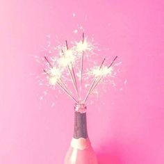 a pink bottle with some sparklers in it