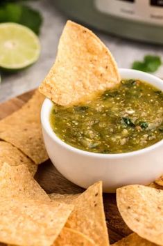 a bowl of salsa with tortilla chips on the side