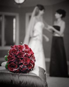 the bride and groom are getting ready to have their wedding pictures taken in black and white