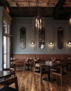 an empty restaurant with wooden tables and chairs