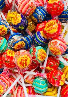 a pile of assorted candy lollipops sitting on top of each other