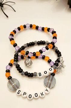 This enchanting spooky bracelet features a captivating combination of black, orange, and purple beads, perfect for adding a touch of Halloween flair to any outfit. The vibrant colors evoke a sense of mystery and fun, making it an ideal accessory for festive occasions. Crafted with care, this bracelet not only showcases a unique design but also offers comfort and durability, ensuring it will be a cherished addition to your jewelry collection. Embrace the spirit of the season with this stylish and playful piece. Black Themed Bracelet For Halloween, Halloween Themed Black Bracelet, Black Halloween Themed Bracelet, Halloween Black Bracelets With Round Beads, Black Round Bead Bracelets For Halloween, Black Round Beaded Bracelets For Halloween, Adjustable Black Beaded Bracelets For Halloween, Halloween Black Adjustable Beaded Bracelets, Halloween Multicolor Beaded Bracelets