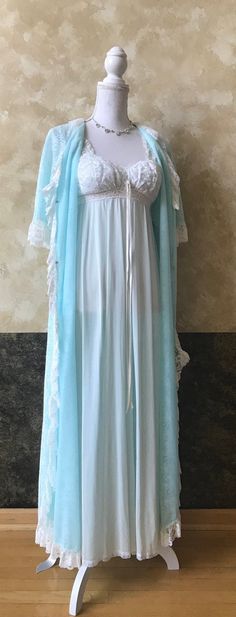 Gorgeous Something Blue Vintage 1950s Blue Long Olga Nightgown with Lingerie Lace Robe Peignoir Set Wedding / Honeymoon Sz S  Label: Robe - Flair Lingerie; Nightgown - Olga  Material: Nylon  Tag Size: Small (probably best fits a size small)  MEASUREMENTS Measurements taken with the garment laying flat and then doubled Nightgown S2S: 6 1/4" B: 34" Under Bust: 24" -30" Length: 51 1/2" Robe / Cover-Up S2S: 13 3/4" Bust: Up to 36" Sleeve: 13 1/2" Length: 51" Please compare measurements to those of c Light Blue Dress For Wedding Night, Vintage Blue Sleepwear, Blue Vintage Wedding Nightgown, Vintage Blue Wedding Nightgown, Blue Floor-length Vintage Gown, Blue Vintage Floor-length Gown, Blue Sheer Vintage Sleepwear, Vintage Blue Sheer Sleepwear, Vintage Light Blue Sleepwear With Lace Trim